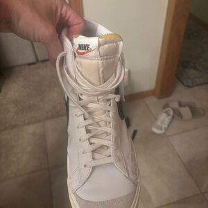 Nike White High-Top Sneaker with Black Swoosh and Orange Logo
